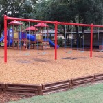 Red and blue playground with swings